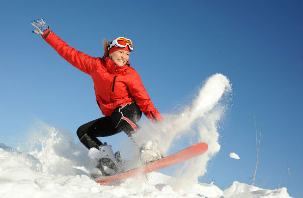 Woman snowboarding in the morning
