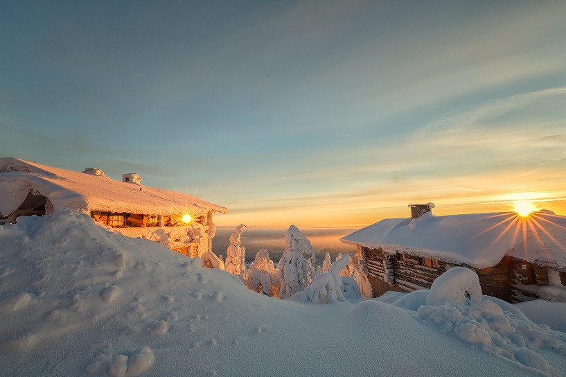 Wooden cabins covered in snow in the mountains in Lapland