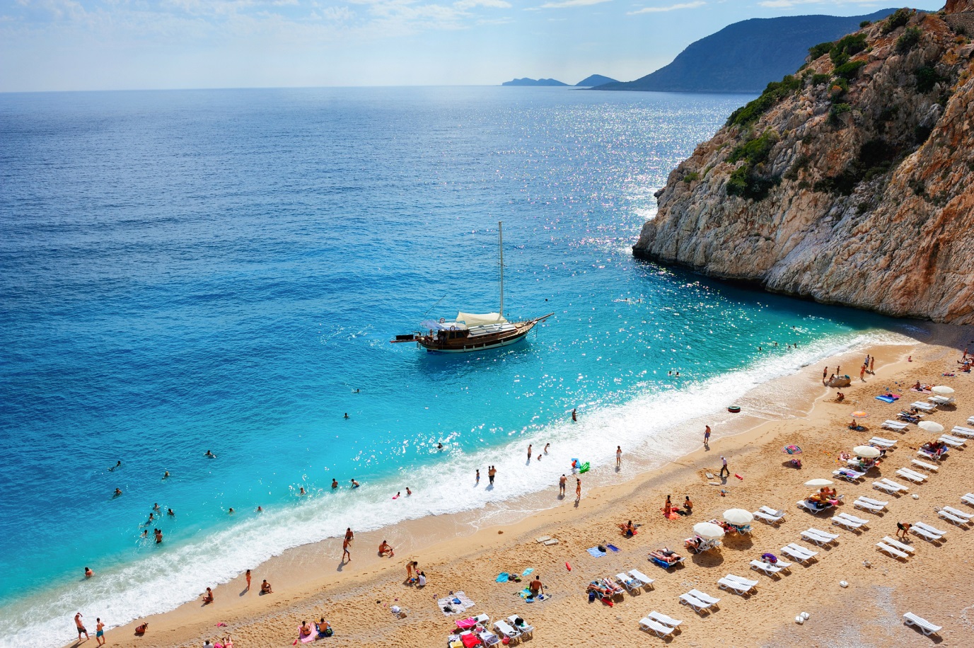 Holidaymakers enjoy the warm Mediterranean sea in the Aegean resort of Fethiye, Turkey