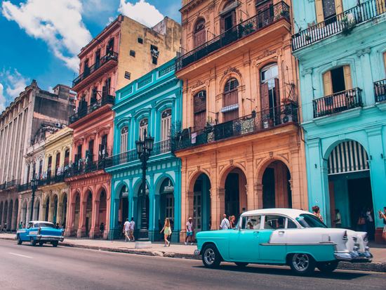 Blue and orange buildings on street in Cuba